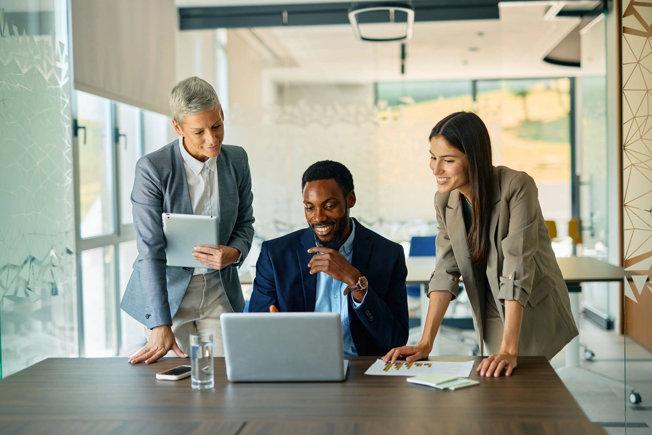 Finance professionals collaborating over reports in a modern office